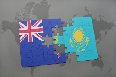 bir dünya haritası arka plan üzerinde Yeni Zelanda ve Kazakistan ulusal bayrağı ile bulmaca