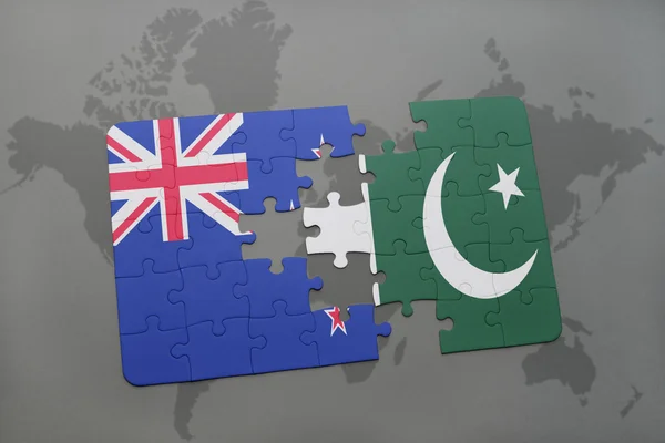 Puzzle with the national flag of new zealand and pakistan on a world map background. 3D illustration — Stock Photo, Image