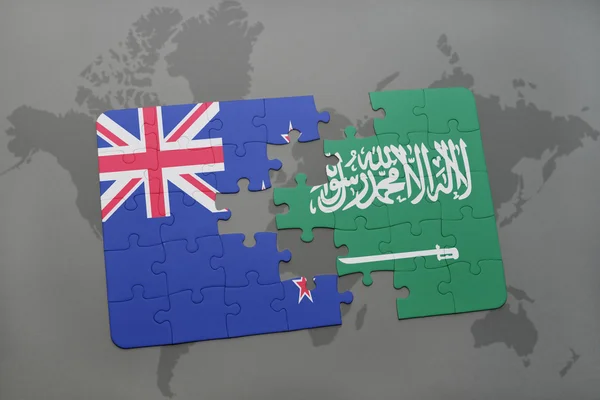 Головоломка з національним прапором нової Зеландії та Саудівської Аравії на фоні карти світу. 3D ілюстрація — стокове фото