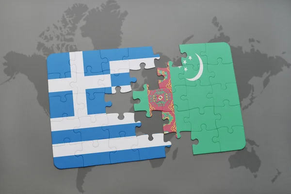 Puzzel met de nationale vlag van Griekenland en Turkmenistan op een wereld kaart achtergrond. — Stockfoto