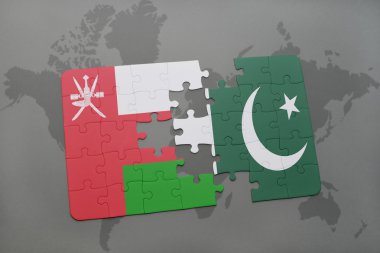 bir dünya haritası arka plan üzerinde umman ve pakistan ulusal bayrağı ile bulmaca.