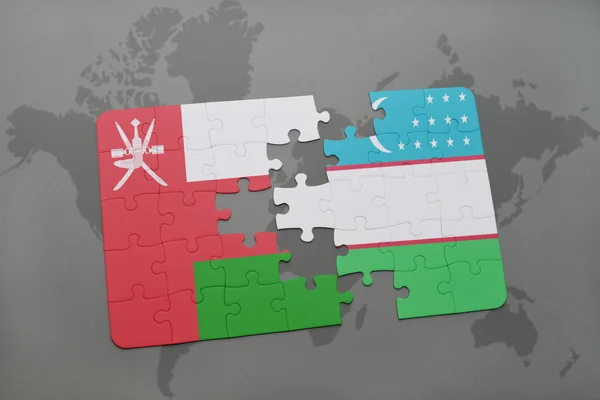 Hádanka s národní vlajkou Ománu a Uzbekistánu na pozadí mapy světa. — Stock fotografie