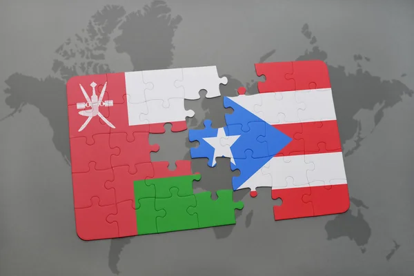 Rompecabezas con la bandera nacional de Omán y Puerto Rico en un mapa del mundo fondo . — Foto de Stock