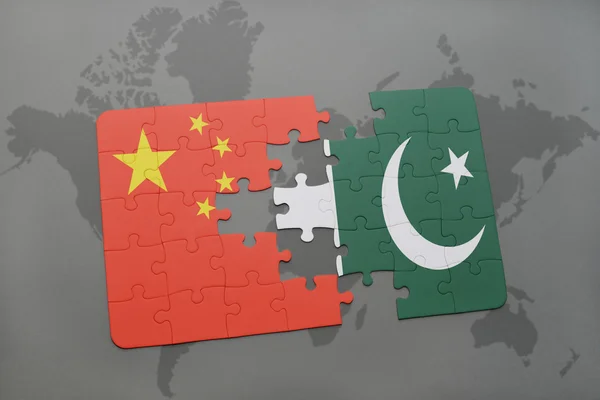 Puzzle with the national flag of china and pakistan on a world map background. — Stock Photo, Image