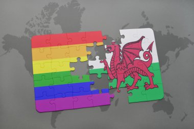 bir dünya haritası arka plan üzerinde galler ve eşcinsel gökkuşağı bayrağı ulusal bayrağı ile bulmaca.