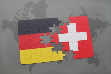 bir dünya haritası arka plan üzerinde Almanya ve İsviçre ulusal bayrağı ile bulmaca.