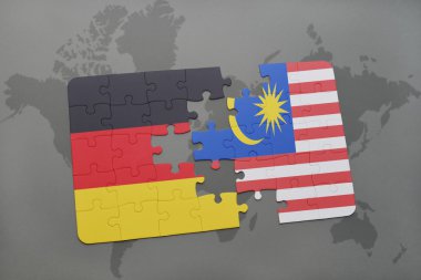 bir dünya haritası arka plan üzerinde Almanya ve Malezya ulusal bayrağı ile bulmaca.