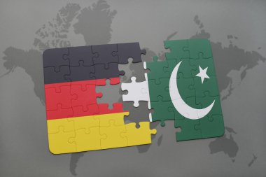 bir dünya haritası arka plan üzerinde Almanya ve Pakistan ulusal bayrağı ile bulmaca.