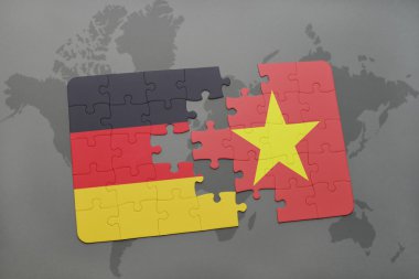 bir dünya haritası arka plan üzerinde Almanya ve Vietnam ulusal bayrağı ile bulmaca.