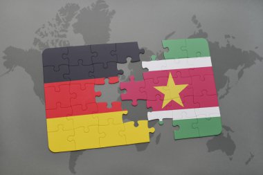 bir dünya haritası arka plan üzerinde Almanya ve surinam ulusal bayrağı ile bulmaca.
