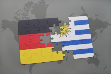 bir dünya haritası arka plan üzerinde Almanya ve Uruguay ulusal bayrağı ile bulmaca.