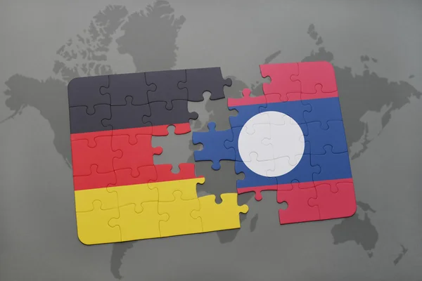 Puzzle mit der Nationalflagge von Deutschland und Laos auf einer Weltkarte Hintergrund. — Stockfoto