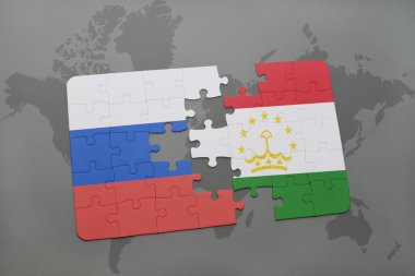 bir dünya haritası arka plan üzerinde Rusya ve Tacikistan ulusal bayrağı ile bulmaca.