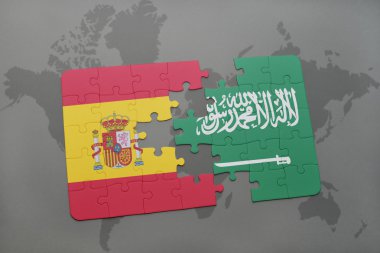 bir dünya haritası arka plan üzerinde İspanya ve Suudi Arabistan ulusal bayrağı ile bulmaca.