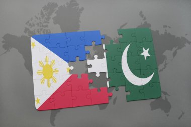bir dünya haritası arka plan üzerinde Filipinler ve Pakistan ulusal bayrağı ile bulmaca.