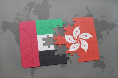 puzzle with the national flag of united arab emirates and hong kong on a world map background.