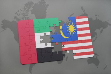 bir dünya haritası arka plan üzerinde birleşik arap emirlikleri ve malezya ulusal bayrağı ile bulmaca.
