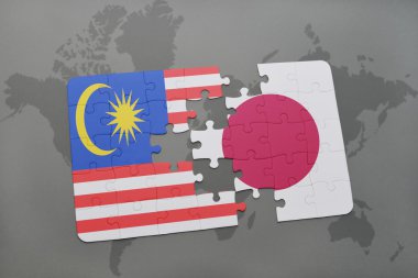 bir dünya haritası arka plan üzerinde Malezya ve Japonya ulusal bayrağı ile bulmaca.
