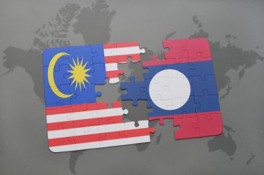 bir dünya haritası arka plan üzerinde malezya ve laos ulusal bayrağı ile bulmaca.