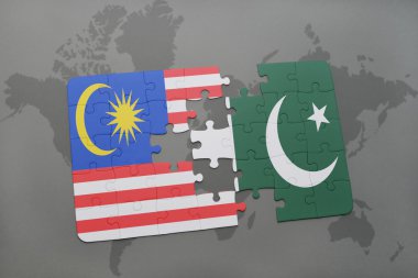 bir dünya haritası arka plan üzerinde malezya ve pakistan ulusal bayrağı ile bulmaca.