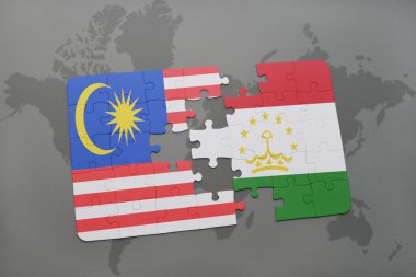 bir dünya haritası arka plan üzerinde malezya ve tacikistan ulusal bayrağı ile bulmaca.