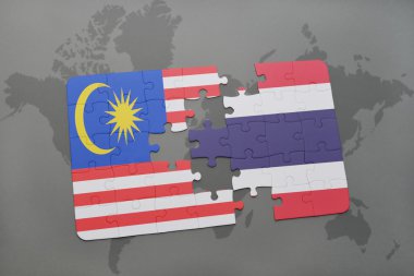 bir dünya haritası arka plan üzerinde malezya ve tayland ulusal bayrağı ile bulmaca.