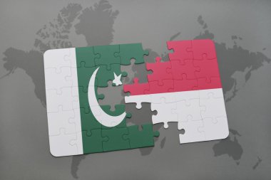bir dünya haritası arka plan üzerinde pakistan ve endonezya ulusal bayrağı ile bulmaca.