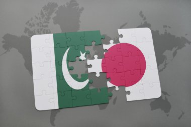 bir dünya haritası arka plan üzerinde pakistan ve Japonya ulusal bayrağı ile bulmaca.