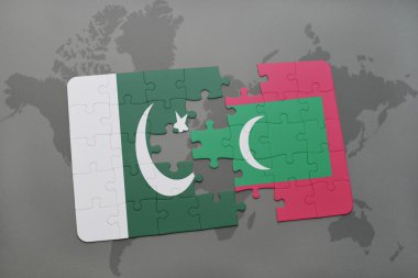 bir dünya haritası arka plan üzerinde pakistan ve Maldivler ulusal bayrağı ile bulmaca.