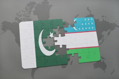bir dünya haritası arka plan üzerinde pakistan ve özbekistan ulusal bayrağı ile bulmaca.