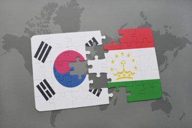 bir dünya haritası arka plan üzerinde güney kore ve tacikistan ulusal bayrağı ile bulmaca.