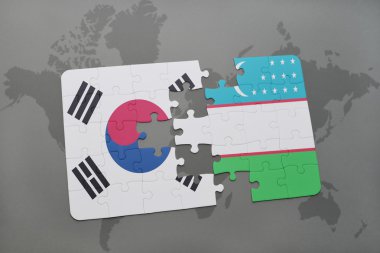 bir dünya haritası arka plan üzerinde güney kore ve özbekistan ulusal bayrağı ile bulmaca.