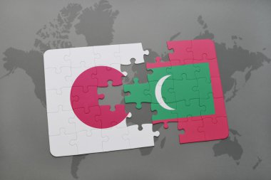 bir dünya haritası arka plan üzerinde Japonya ve Maldivler ulusal bayrağı ile bulmaca.
