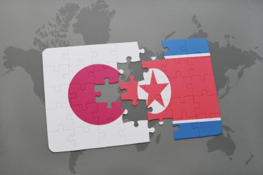 bir dünya haritası arka plan üzerinde Japonya ve Kuzey Kore ulusal bayrağı ile bulmaca.