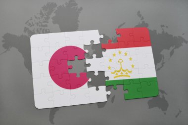 bir dünya haritası arka plan üzerinde Japonya ve Tacikistan ulusal bayrağı ile bulmaca.