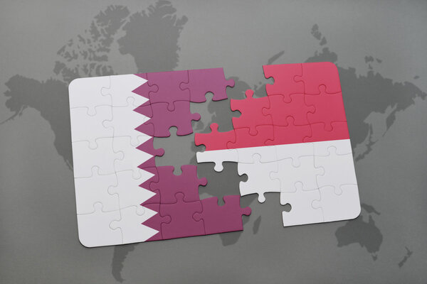 puzzle with the national flag of qatar and indonesia on a world map background.