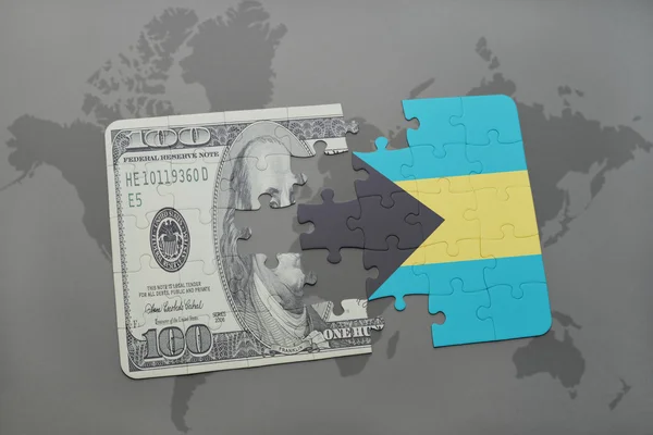 Quebra-cabeça com a bandeira nacional das bahamas e nota de dólar sobre um fundo de mapa mundial . — Fotografia de Stock