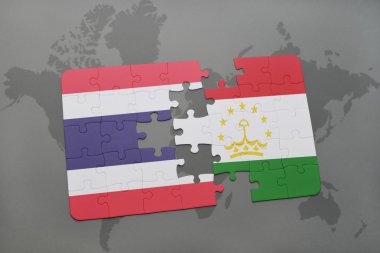bir dünya haritası arka plan üzerinde tayland ve tacikistan ulusal bayrağı ile bulmaca.