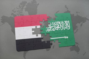 bir dünya haritası arka plan üzerinde Yemen ve Suudi Arabistan ulusal bayrağı ile bulmaca.