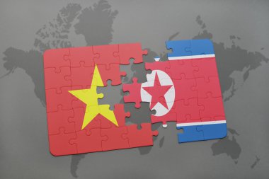 bir dünya haritası arka plan üzerinde Vietnam ve Kuzey Kore ulusal bayrağı ile bulmaca.