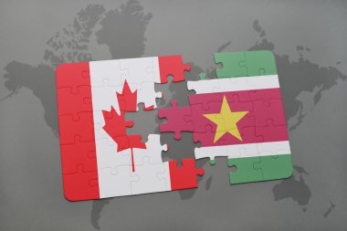 bir dünya haritası arka plan üzerinde kanada ve surinam ulusal bayrağı ile bulmaca.