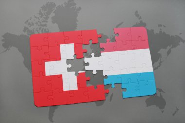 bir dünya haritası arka plan üzerinde İsviçre ve Lüksemburg ulusal bayrağı ile bulmaca.