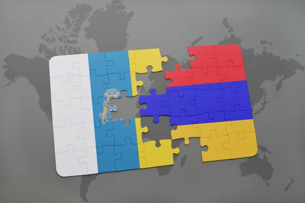 Puzzel met de nationale vlag van de Canarische eilanden en Armenië op een wereld kaart achtergrond. — Stockfoto