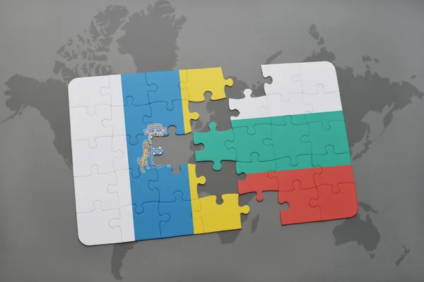 Puzzle with the national flag of canary islands and bulgaria on a world map background. — Stock Photo, Image