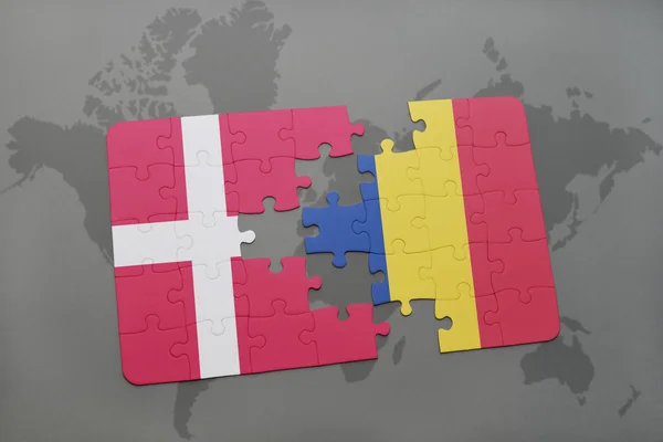 Quebra-cabeça com a bandeira nacional de denmark e romania em um fundo de mapa do mundo . — Fotografia de Stock