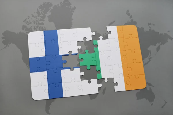 puzzle with the national flag of finland and ireland on a world map background.