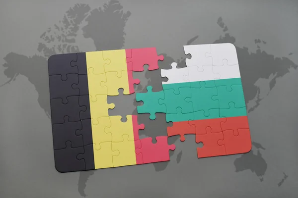 Puzzel met de nationale vlag van België en Bulgarije op een wereld kaart achtergrond. — Stockfoto