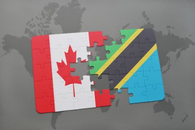 bir dünya haritası arka plan üzerinde kanada ve tanzanya ulusal bayrağı ile bulmaca.