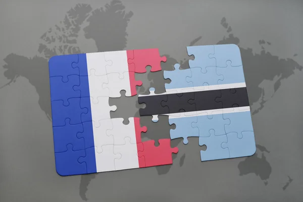 Παζλ με την εθνική σημαία της Γαλλίας και της Μποτσουάνα σε ένα παγκόσμιο φόντο χάρτη. — Φωτογραφία Αρχείου