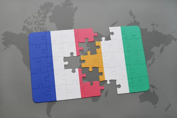 Puzzle with the national flag of france and cote divoire on a world map background. — Stock Photo, Image
